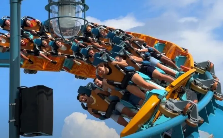 Thrill-seekers gripping the coaster as it climbs a dramatic incline