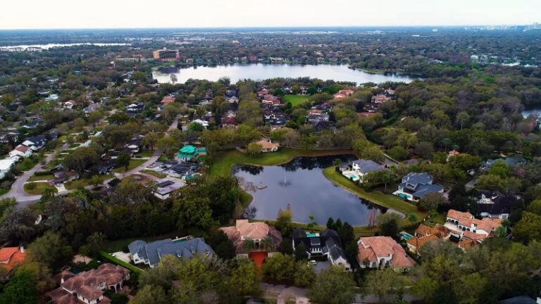 Aerial view of tree-filled residential area near lakes, showing one of the top neighborhoods in Orlando with strong home value