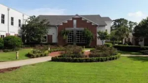 One of the top-rated private schools in Southwest Orlando with a brick chapel, manicured lawn, and central cross structure