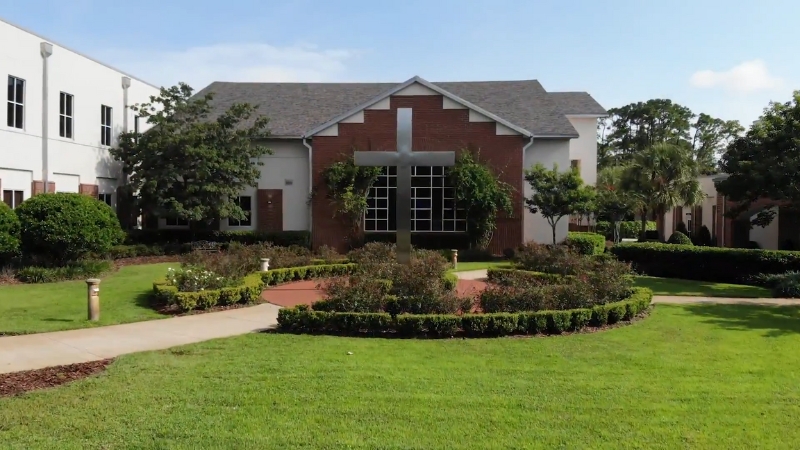One of the top-rated private schools in Southwest Orlando with a brick chapel, manicured lawn, and central cross structure