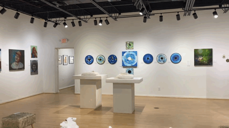 An art gallery in Orlando displays student artwork created during local art camps, featuring paintings and mixed media projects