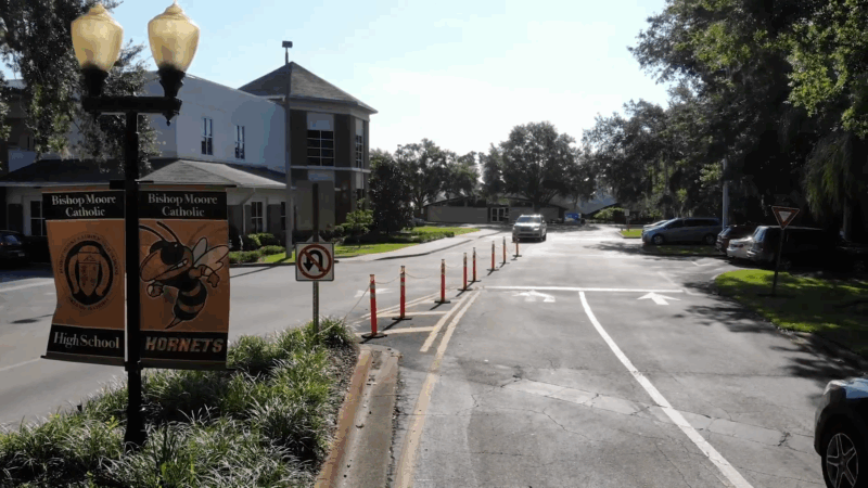 Entrance road to Bishop Moore Catholic High School in Orlando with school banners and directional signs visible