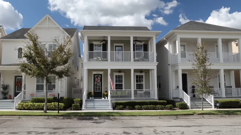 Row of well-kept two-story homes with front porches in Celebration, Orlando
