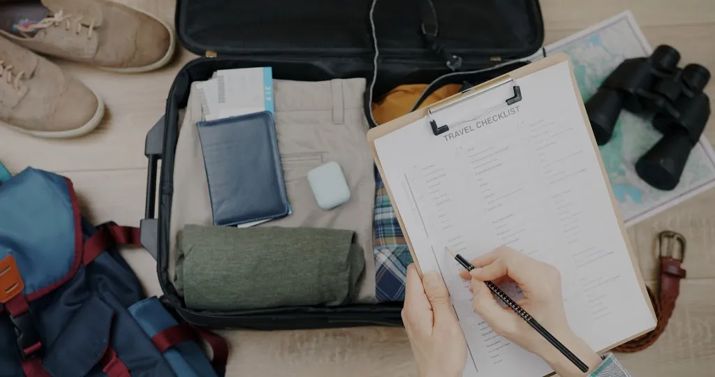 Preparing a travel checklist for a family journey from Florida to Missouri, suitcase and items ready