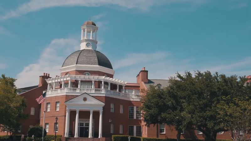 Front view of Lake Highland Preparatory School in Orlando with its red brick exterior and white dome