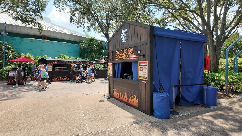 Visitors walking past a BBQ food stall at the SeaWorld Bands, Brew and BBQ festival, one of the most popular events in Orlando