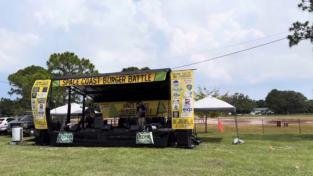 Outdoor burger-themed stage at the Space Coast Burger Battle