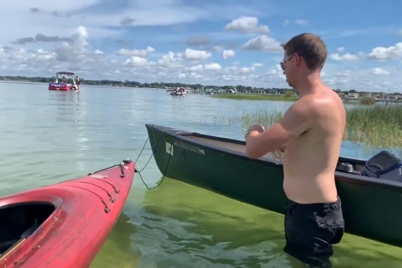 Residents enjoying social life and boating activities on Lake Conway with kayaks and small boats